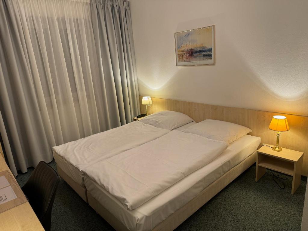 Postel nebo postele na pokoji v ubytování Hotel Occam