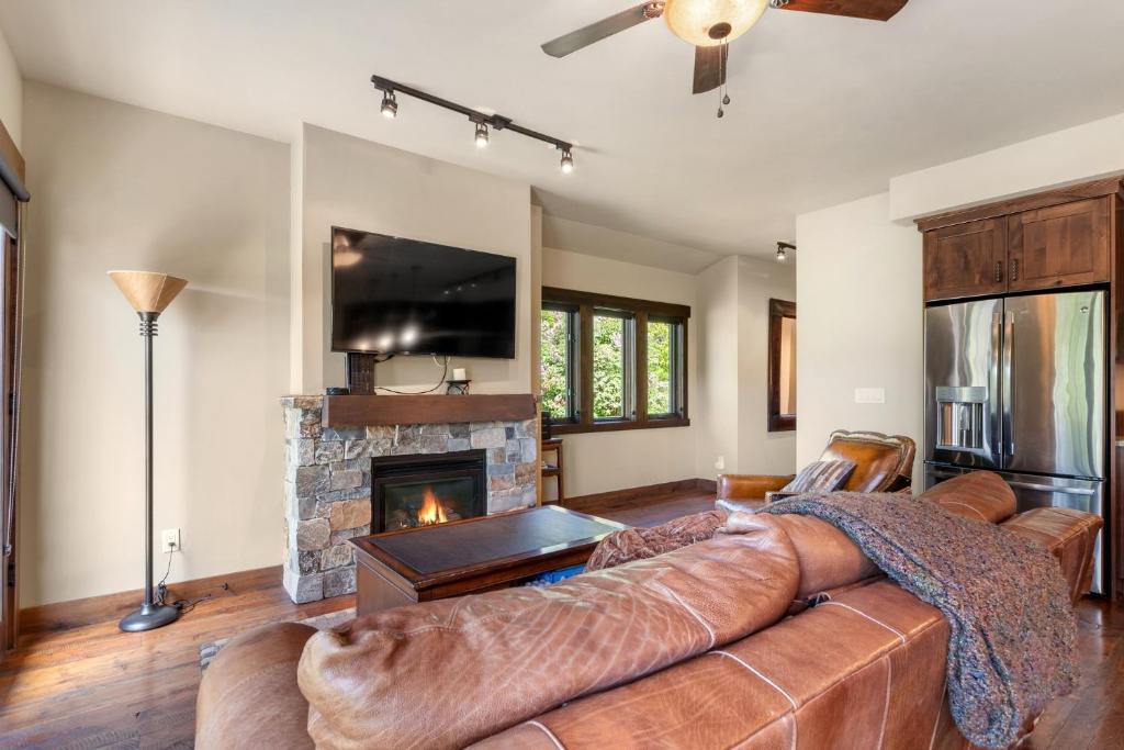 a living room with a couch and a fireplace at Landing A in Whitefish