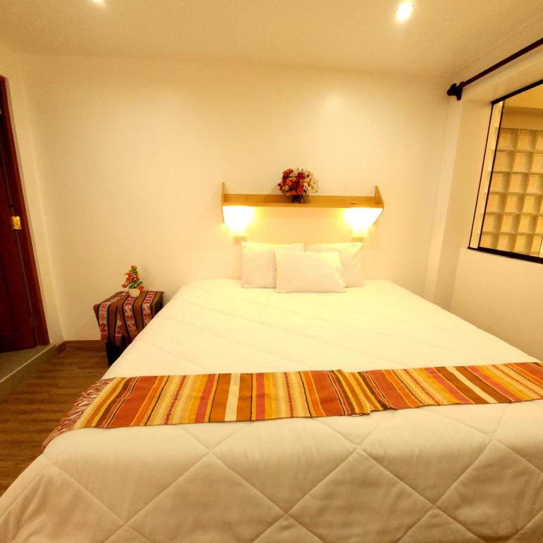 Postel nebo postele na pokoji v ubytování Hotel Ruta Amazónica Machupicchu