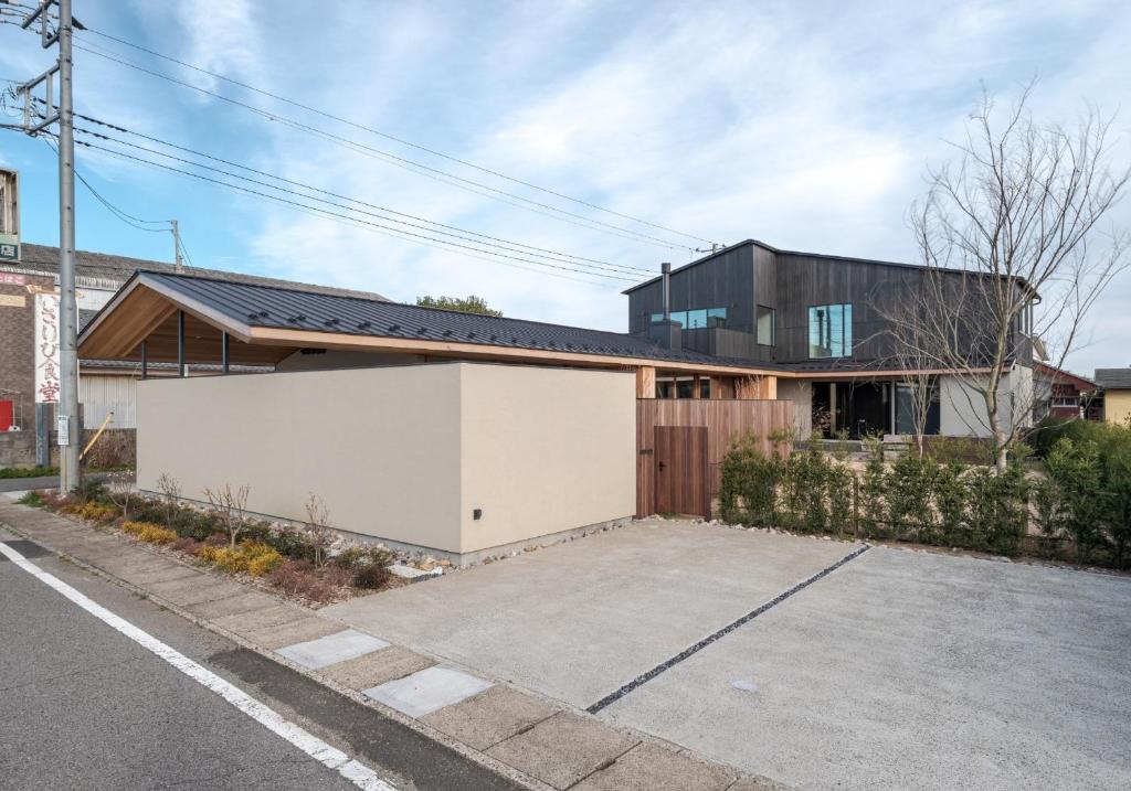 a house with a white garage in front of a street at Kujukuri point 59 - Vacation STAY 49043v in Kujukuri