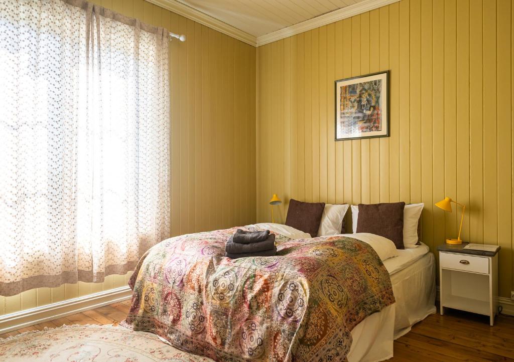 a bedroom with a bed and a window at Kollen Slottet in Oslo