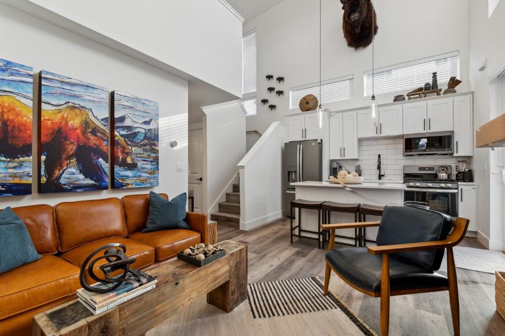 a living room with a couch and a kitchen at Quarry A35 in Whitefish