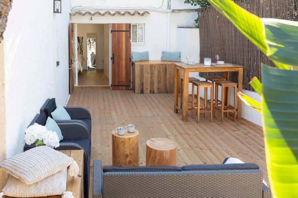 a patio with a couch and a table and chairs at Studio à 200m de la plage de Tahiti beach et à proximité du centre de St Tropez in Saint-Tropez