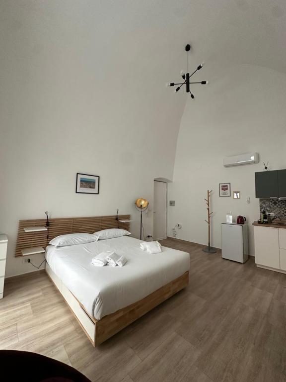 a bedroom with a large white bed in a room at Casa Garruba 99 in Bari