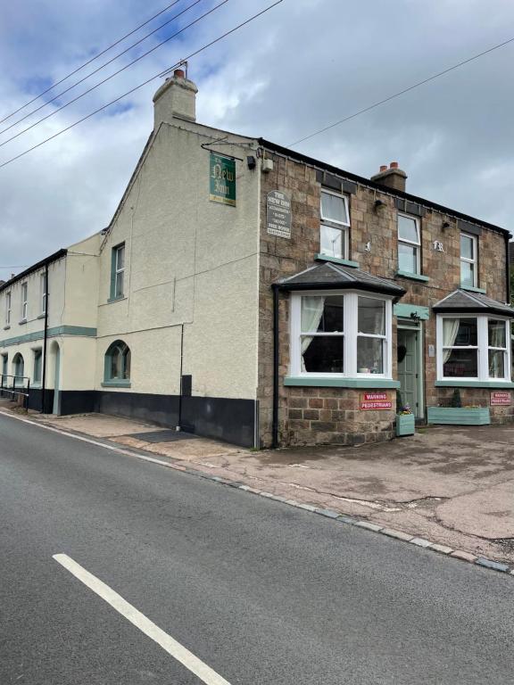 a brick building on the side of a street at The New Inn in Cinderford