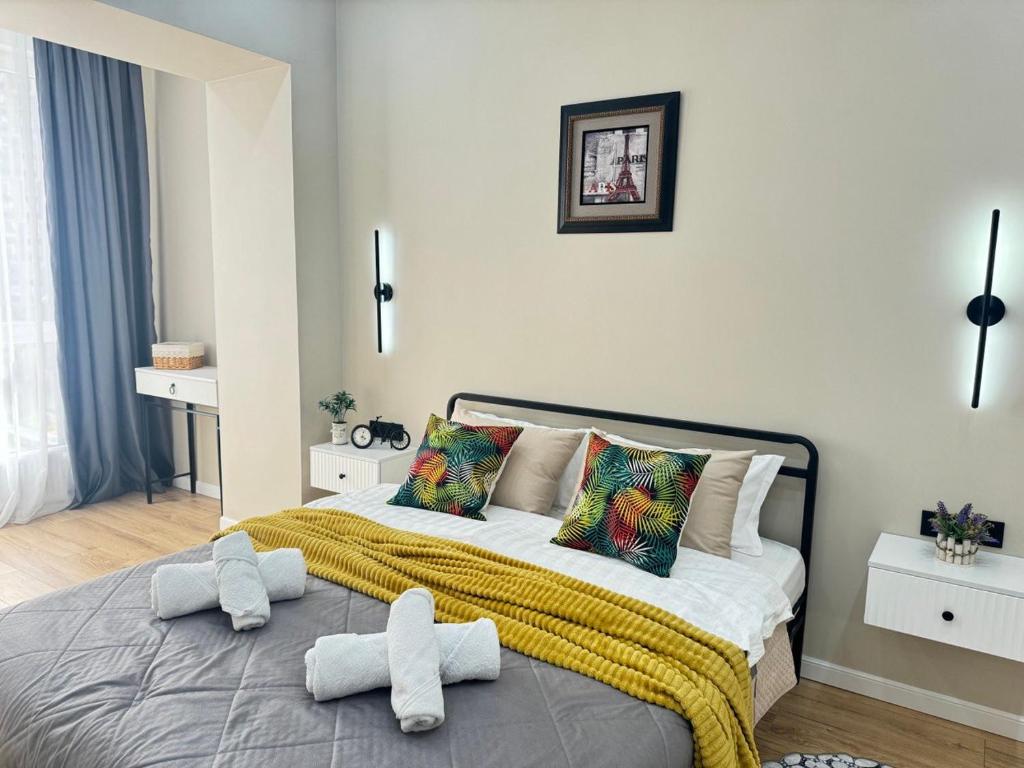 a bedroom with a bed with two towels on it at 2-room apartment ЖК Комфорт Сити near MEGA, flat 15 in Almaty