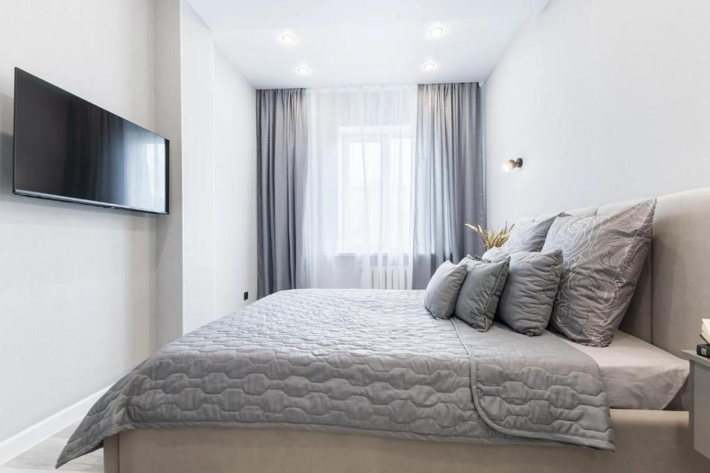 a bedroom with a bed and a flat screen tv at Pleyel welcome to my apps in Saint-Denis