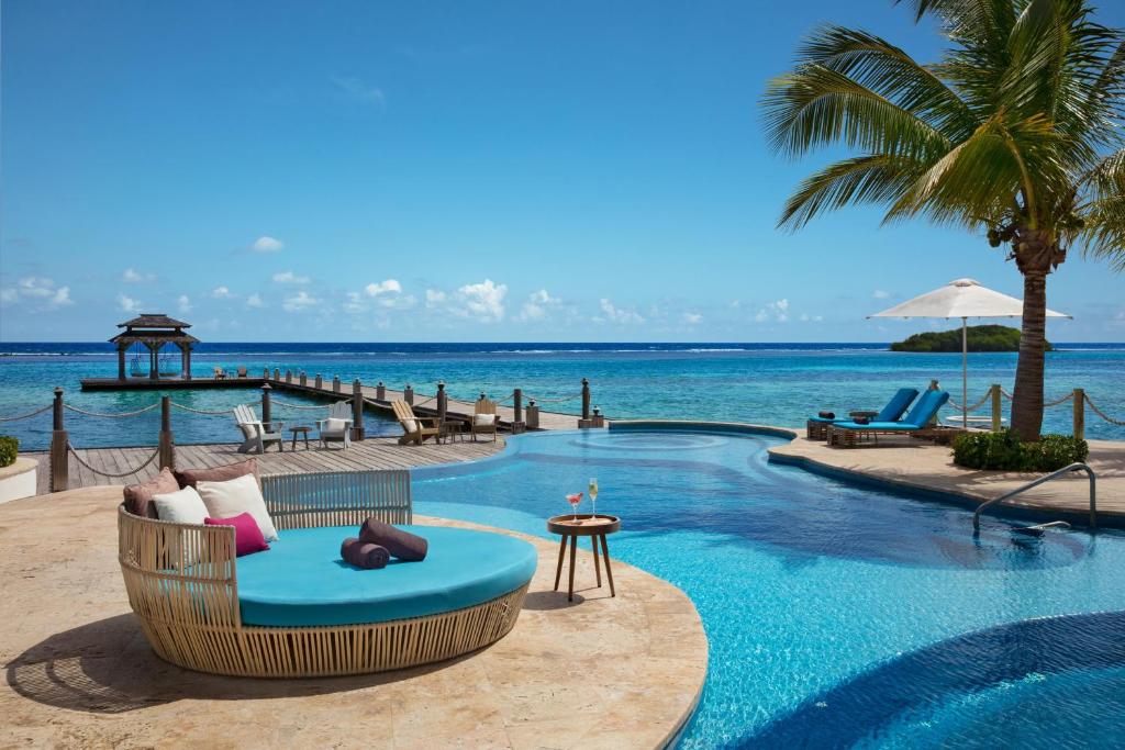 a resort with a swimming pool and the ocean at Zoetry Montego Bay in Montego Bay