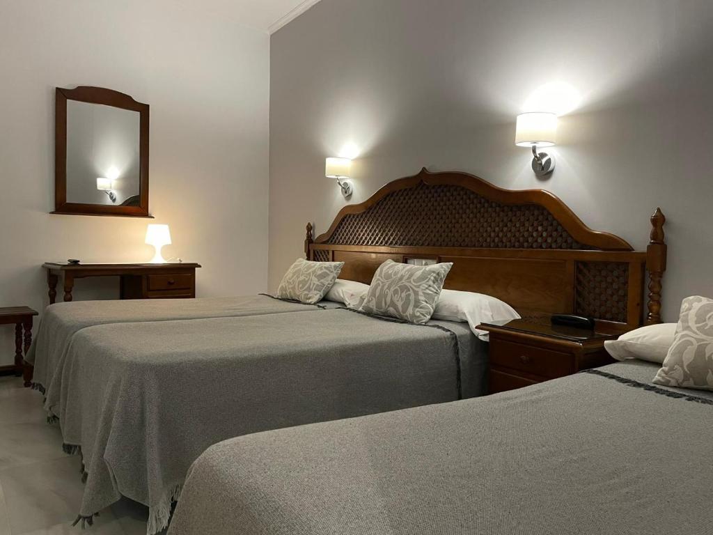 Postel nebo postele na pokoji v ubytování Hotel Los Omeyas