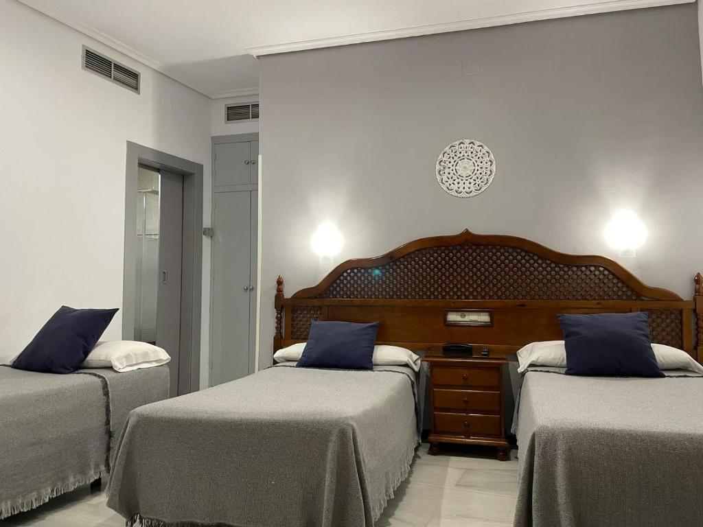 Postel nebo postele na pokoji v ubytování Hotel Los Omeyas