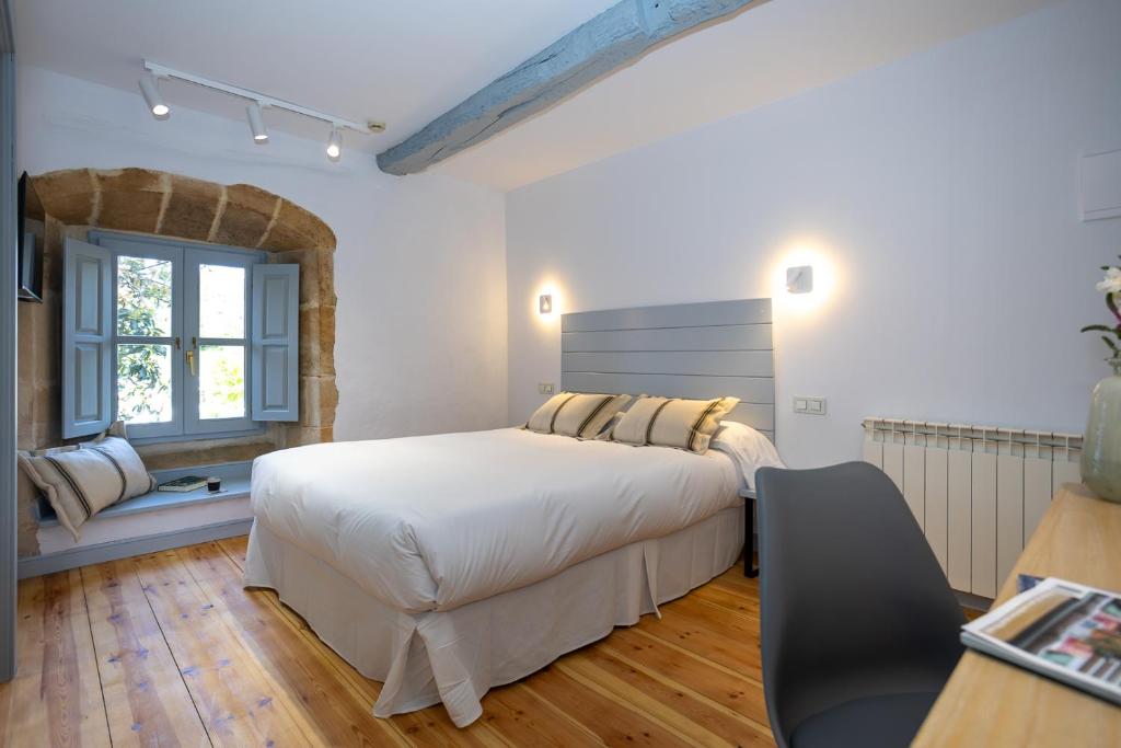 a bedroom with a large bed and a window at Casona Las Cinco Calderas in Galizano