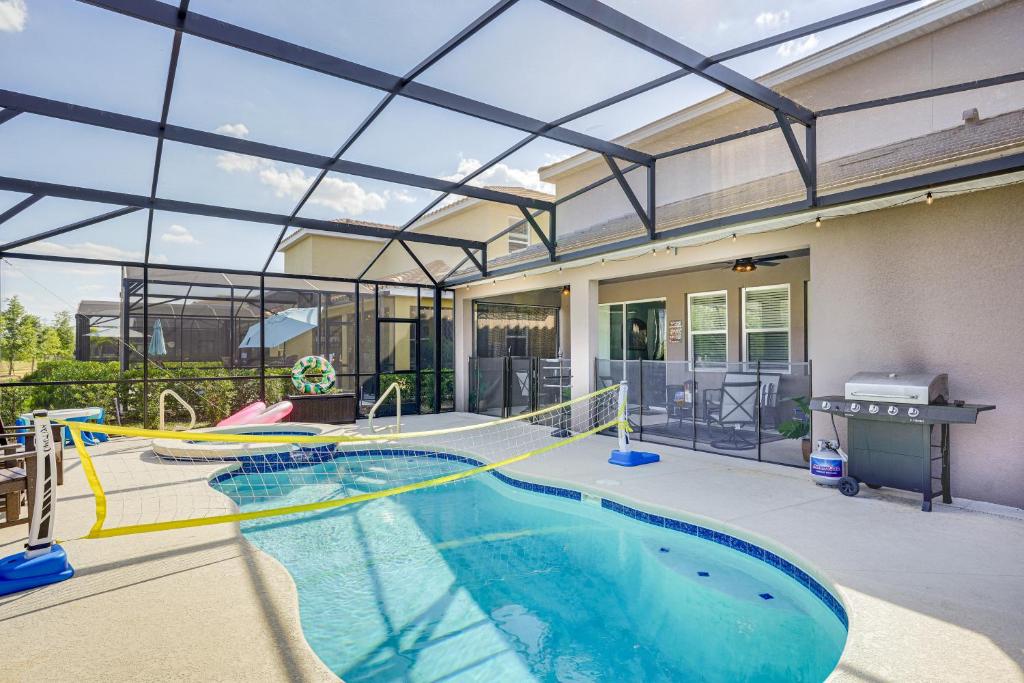an indoor swimming pool with a glass ceiling at Disney Area Vacation Rental with Game Room and Pool! in Davenport