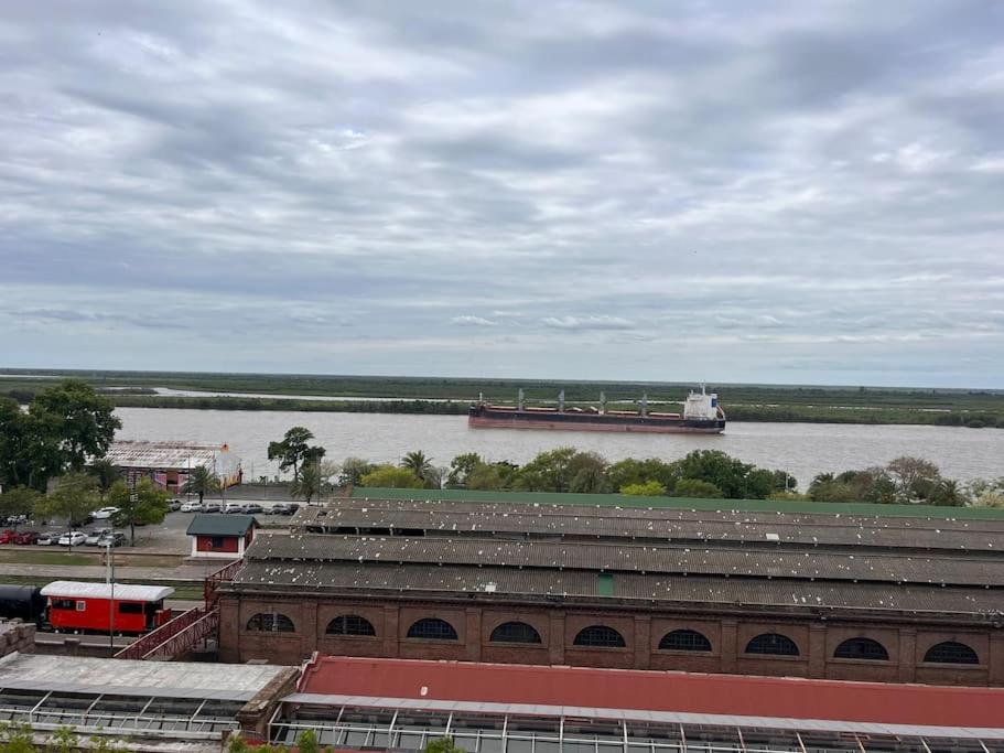 a large barge is on the water next to a river at Ushuaia 1 in Rosario