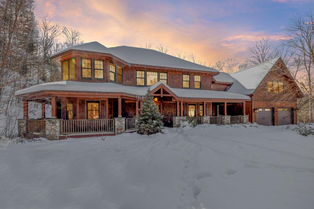 a house with snow on the ground in front of it at The Grand Lodge Lux Family Escape, Hot Tub, Sauna in Lincoln