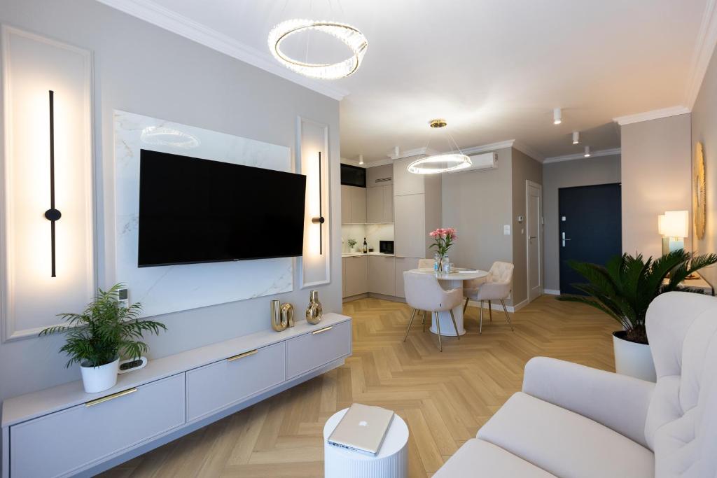 a living room with a flat screen tv on a wall at ZB Apartment GOLD Piekary Bytom Sląskie Siemianowice Chorzów in Piekary Śląskie