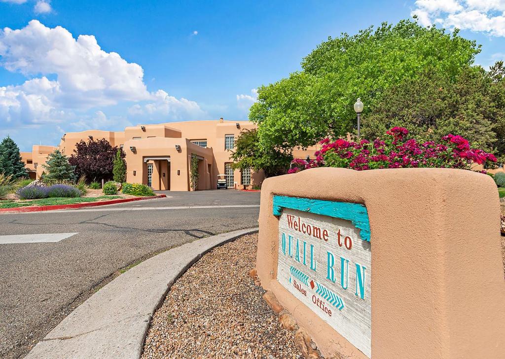 a sign on the side of a street at Quail run in Santa Fe