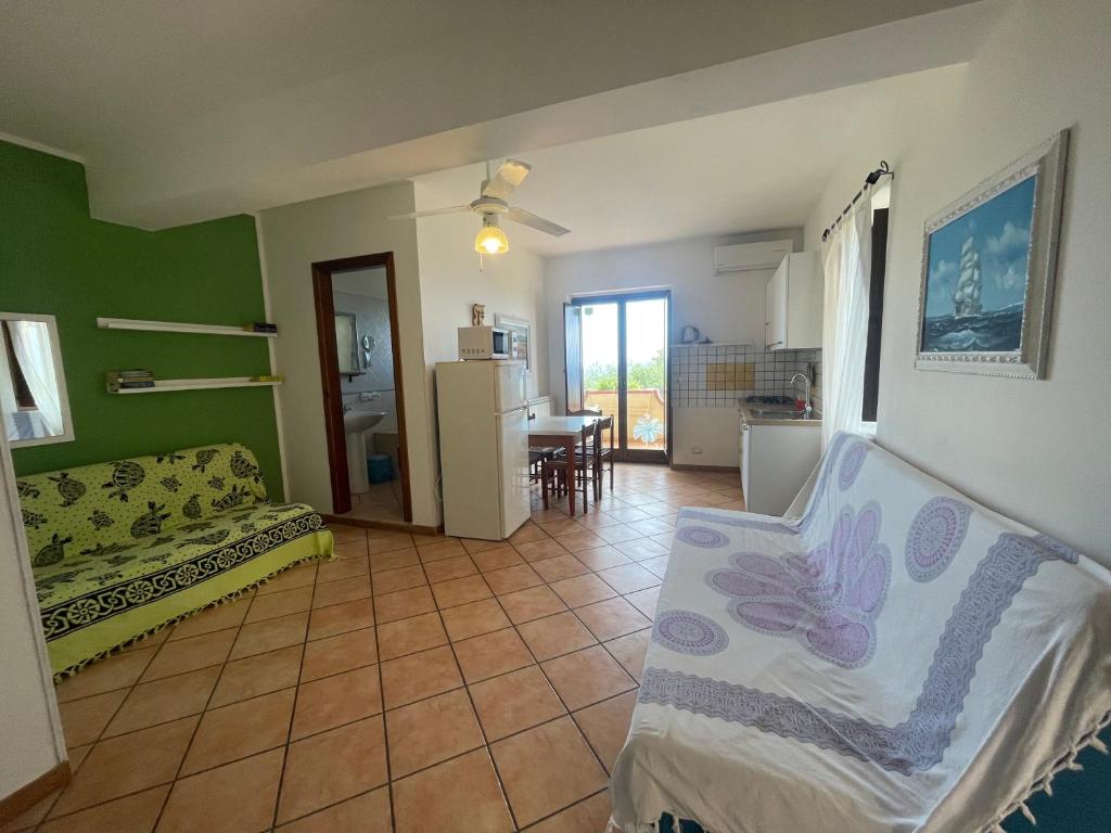 a living room with a couch and a kitchen at Appartamenti Pousada Michelino in Parghelia