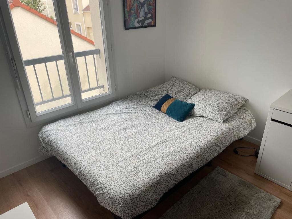 Un pat sau paturi într-o cameră la Maison proche aéroport d’Orly