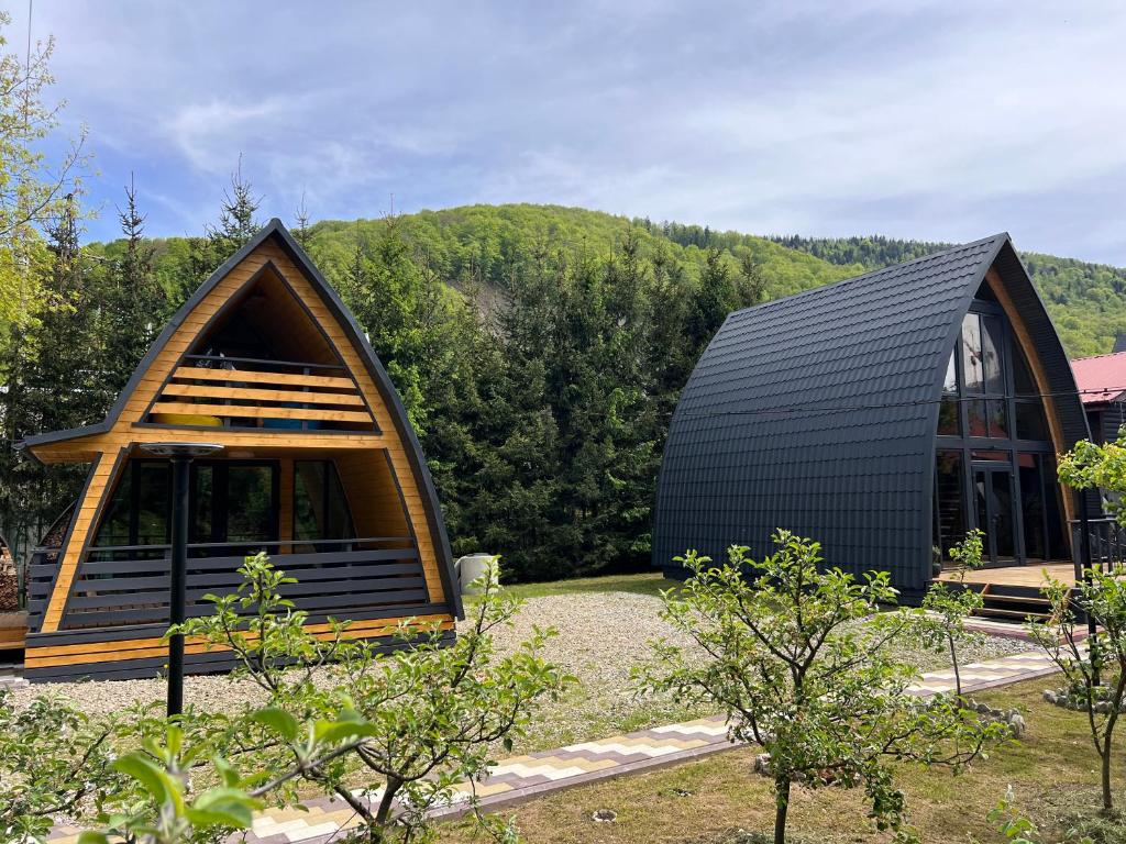 a small house with a black roof at U Yaroslava Hotel in Yaremche