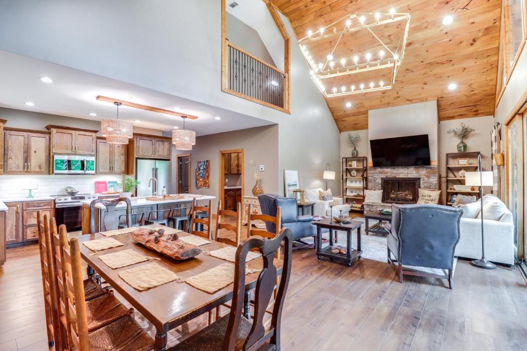 a dining room and living room with a table and a kitchen at Gorgeous Drasco Home Near Greers Ferry Lake! in Heber Springs
