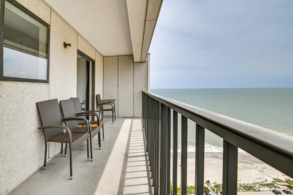 a balcony with chairs and a view of the ocean at Mod Myrtle Beach Resort Condo with Beach Access in Myrtle Beach