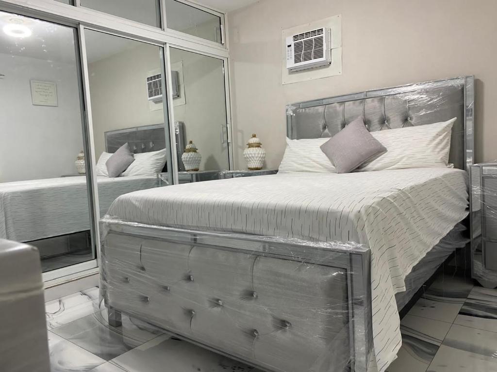 a bedroom with a large bed and a large mirror at María house in Santo Domingo