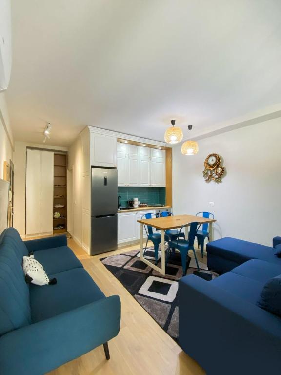a living room with a blue couch and a table at Albanian Dream Escape Apartment in Golem