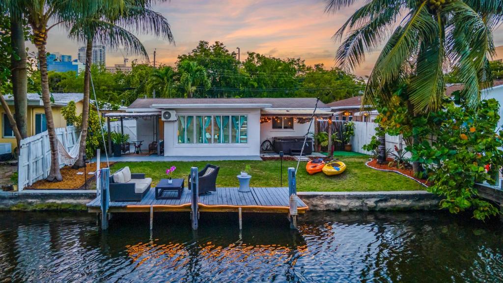 a house with a dock in the water at RiverWalk Villa I Private Dock & Hot Tub in Fort Lauderdale
