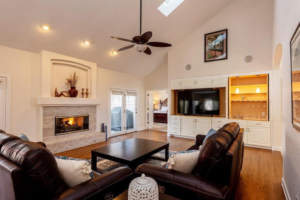 a living room with leather furniture and a fireplace at Luxurious 4BR Retreat - Pool Table & Chic Amenities in Boulder