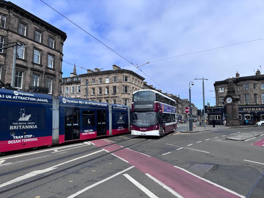 a double decker bus driving down a city street at Haymarket Hostel in Edinburgh