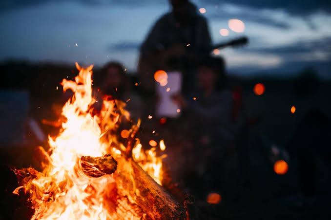 a bonfire with a person standing in the background at Blue Willow Bathurst Country Getaway in Bathurst