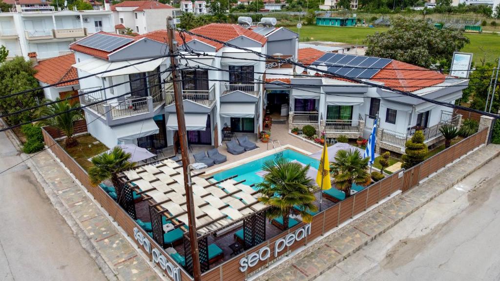 an aerial view of a house with a swimming pool at Sea Pearl Luxury Apartments in Nea Vrasna