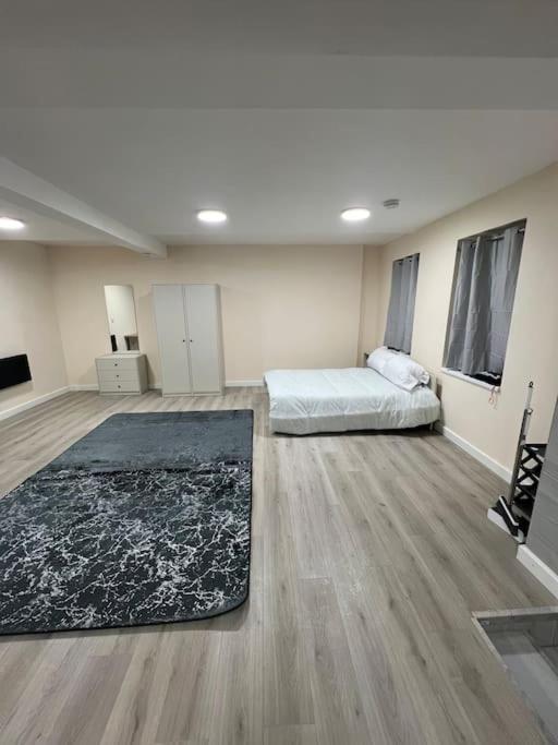 a large room with a bed and a rug at studio flat in Spinney Hill