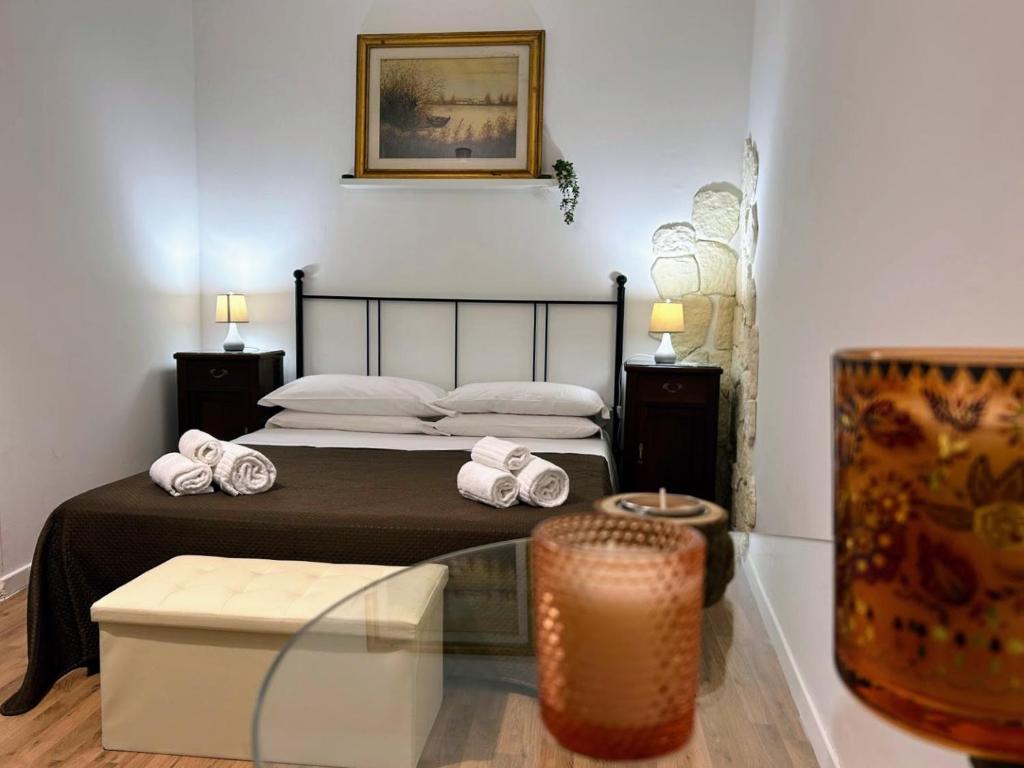 a bedroom with a bed with towels on it at Sweet Lotus Apartment in Taormina