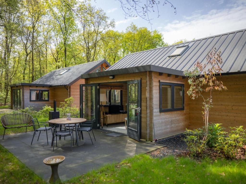 a tiny house with a patio and a table at Amaryllis in Soesterberg