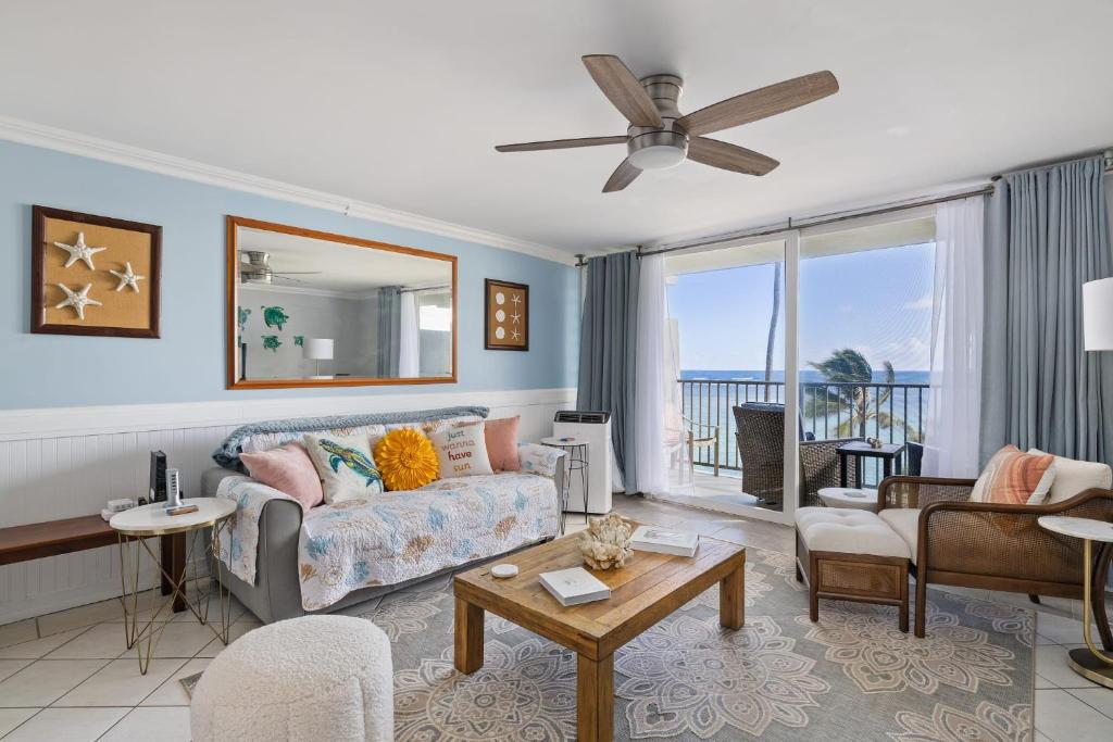a living room with a couch and a table at NEW Beachfront Condo & Amazing Views in Hauula