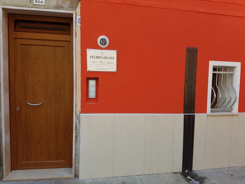 a building with a door and a sign on it at CHIOGGIA PLAYA in Chioggia