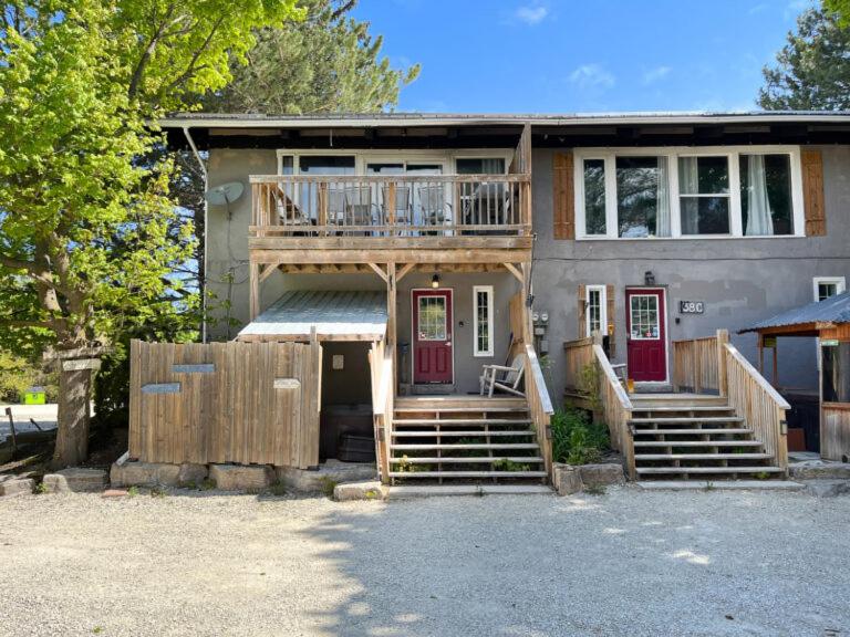 a house with a deck and stairs in front of it at Happy Daze Big Space Near Village Lots of fun Hot Tub in Blue Mountains