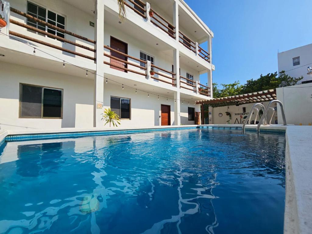 a large swimming pool in front of a building at Casa aloha-Isla Holbox in Holbox Island