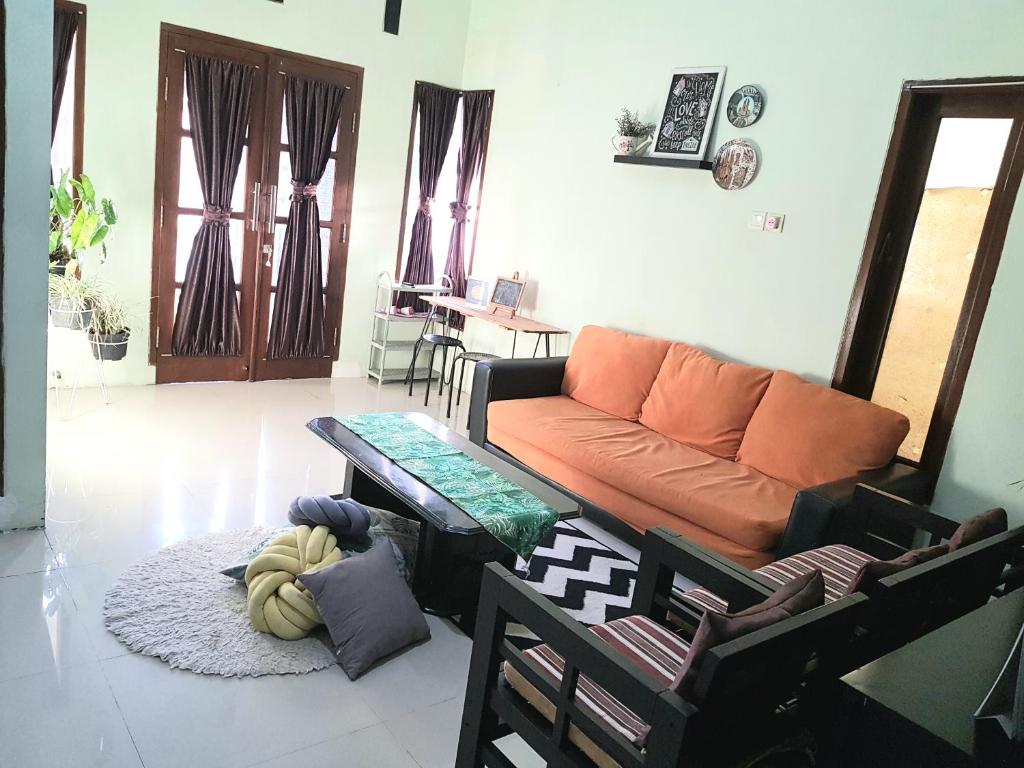 uma sala de estar com um sofá e uma mesa em Hansel Homestay em Batu