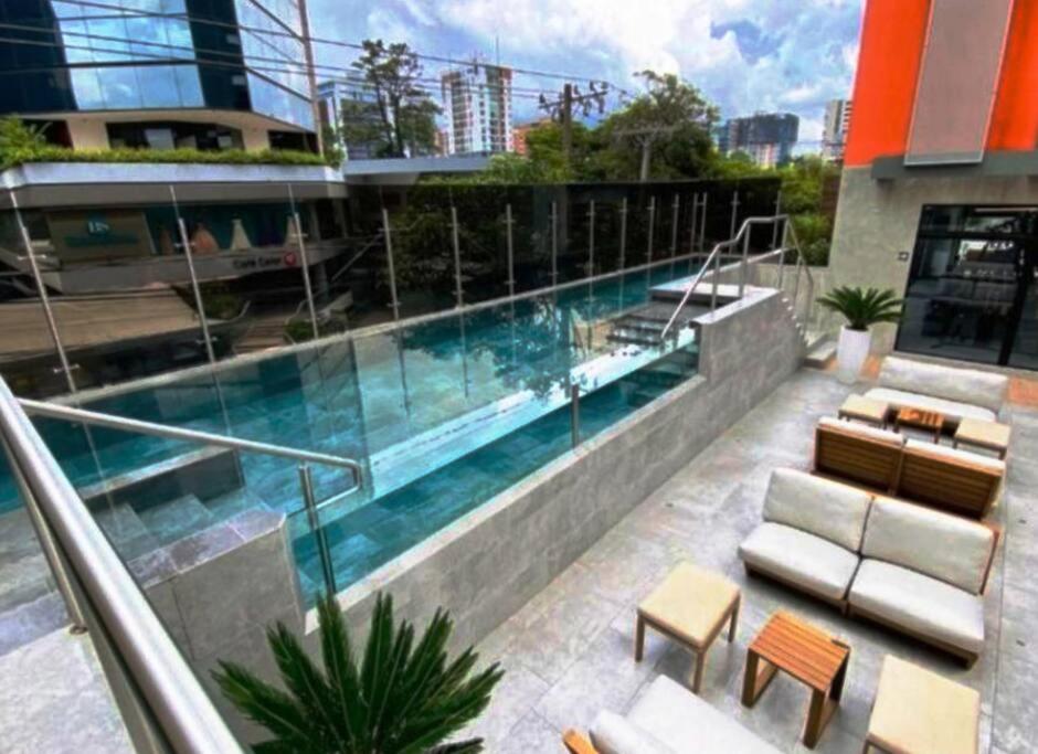 a swimming pool on the side of a building at Deluxe Apto Guatemala zona 10 Edificio EON in Guatemala