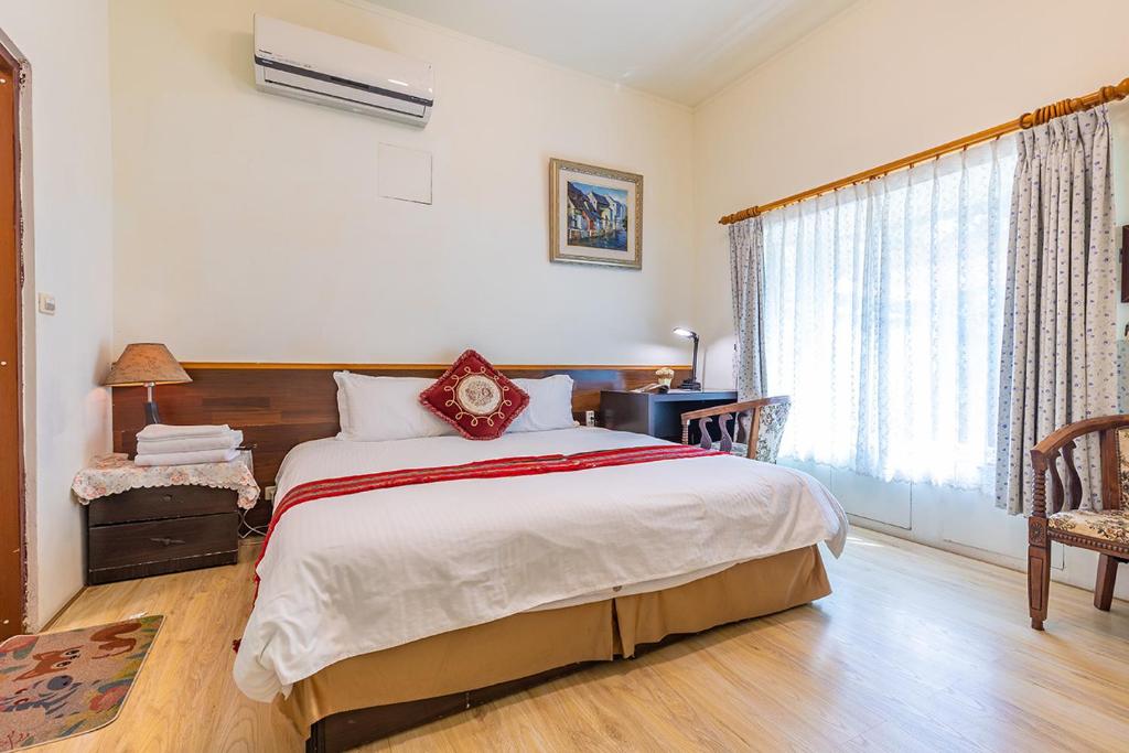 Postel nebo postele na pokoji v ubytování Yishin Garden B&B