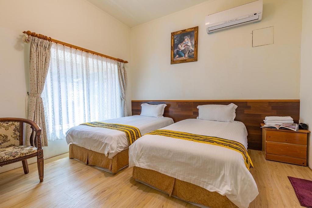 Postel nebo postele na pokoji v ubytování Yishin Garden B&B