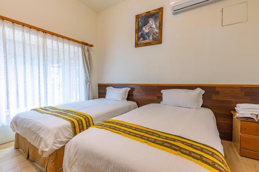 Postel nebo postele na pokoji v ubytování Yishin Garden B&B