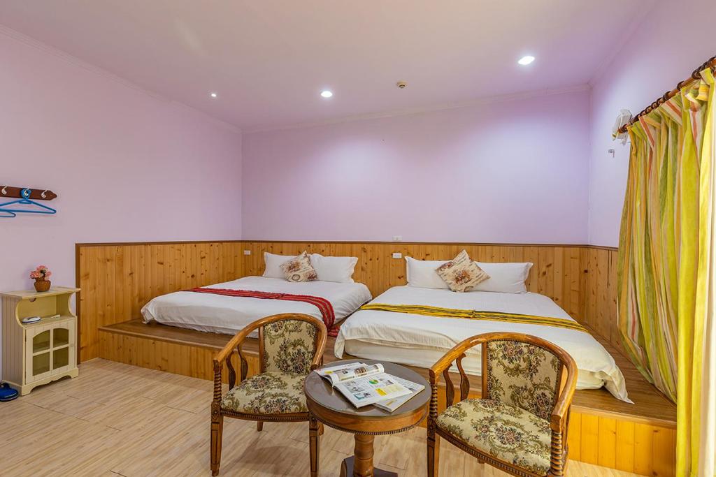 Postel nebo postele na pokoji v ubytování Yishin Garden B&B