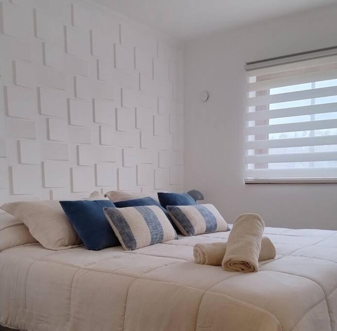a white couch with pillows on it in a room at Nuevo y Maravilloso Dpto. 44m2 in Los Ángeles