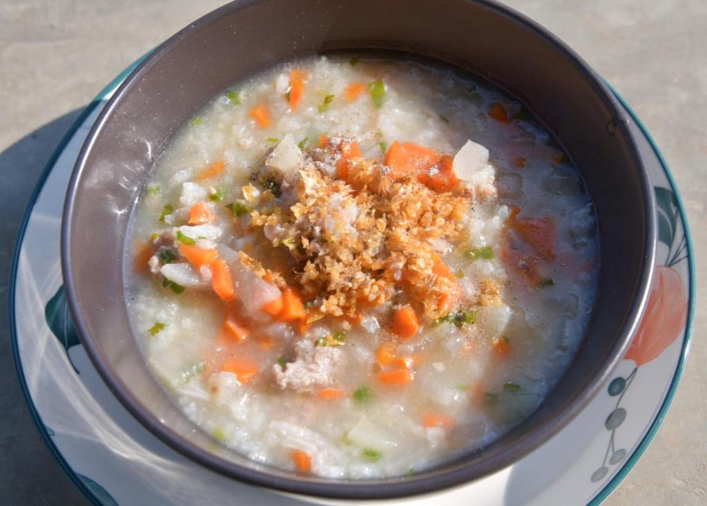 a pot of soup with carrots and stuffing in it at NiNo San Glamping - Pak Chong in Ban Nong Ka Cha