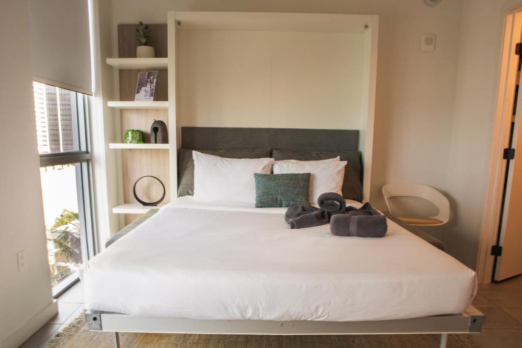 sypialnia z dużym łóżkiem z białą pościelą w obiekcie Miami High Town View 1610 w Miami