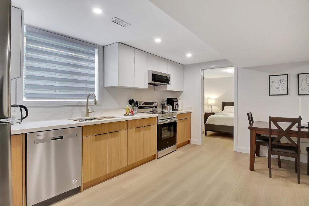 a kitchen and dining room with a table and a room with a bed at New Two Bedroom Apartment In Waterloo in Waterloo