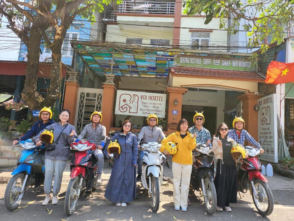 a group of people wearing yellow helmets on their motorcycles at Voi Hostel in Mèo Vạc